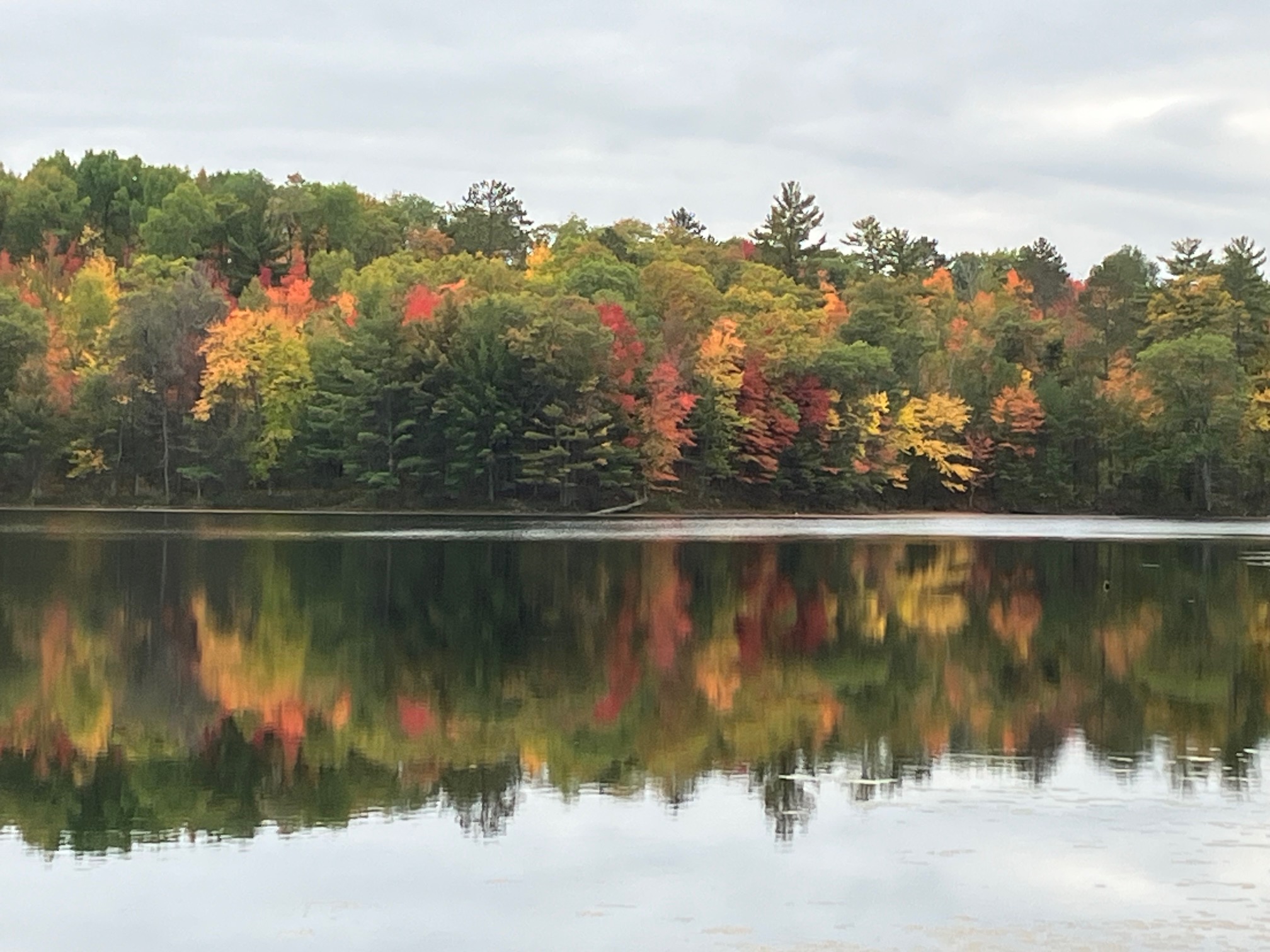 Brilliant autumn colors reflected in a still Northwoods lake