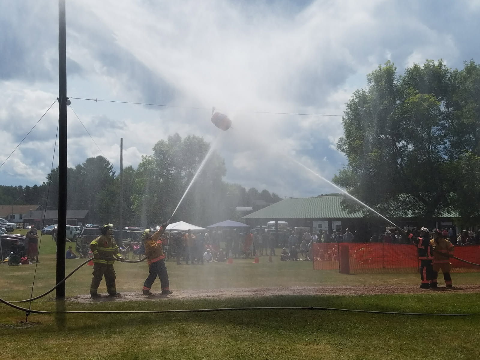 Firefighters running a fire-hose training demonstration