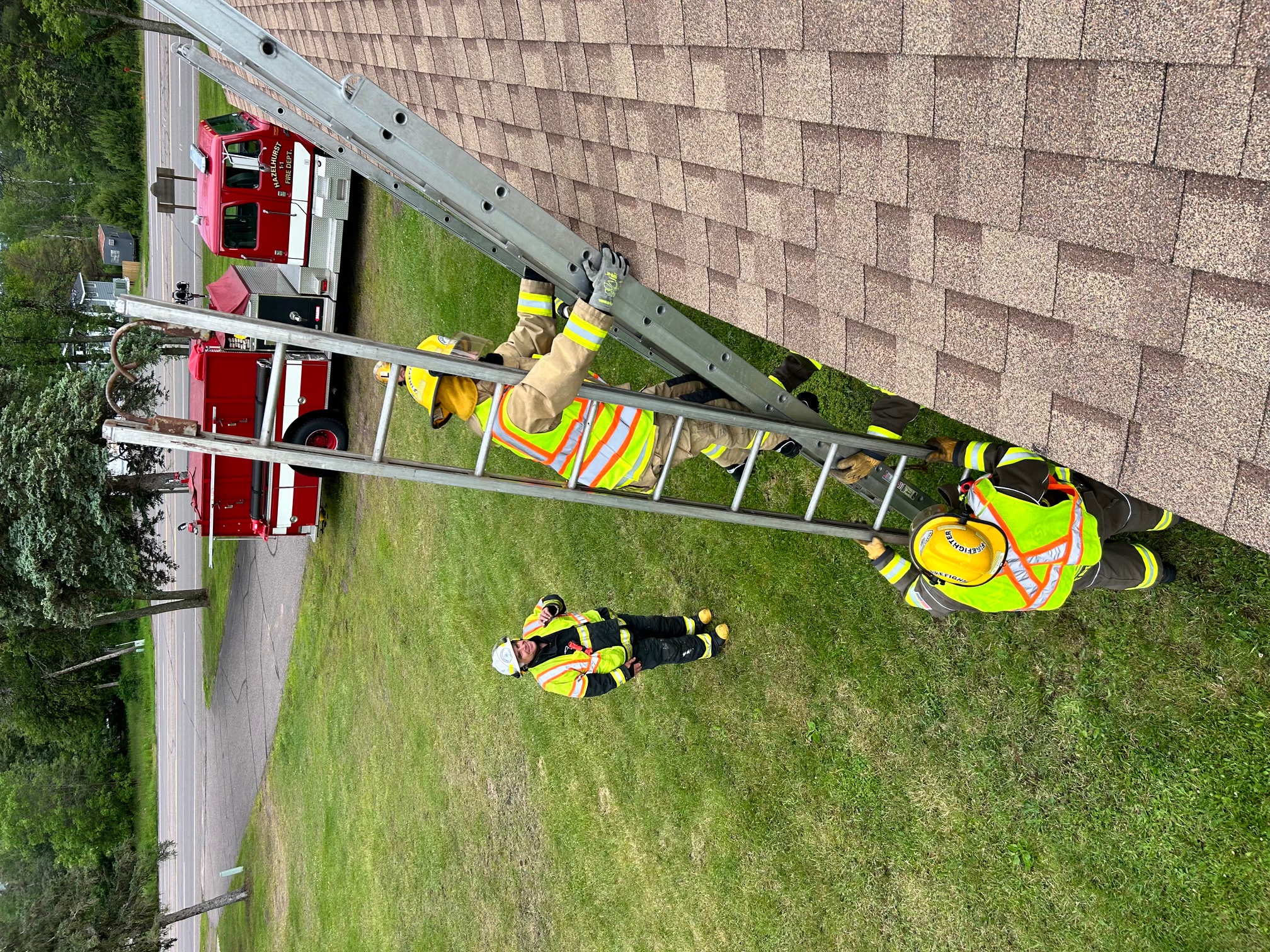 A firefighter climbing an extension ladder during training