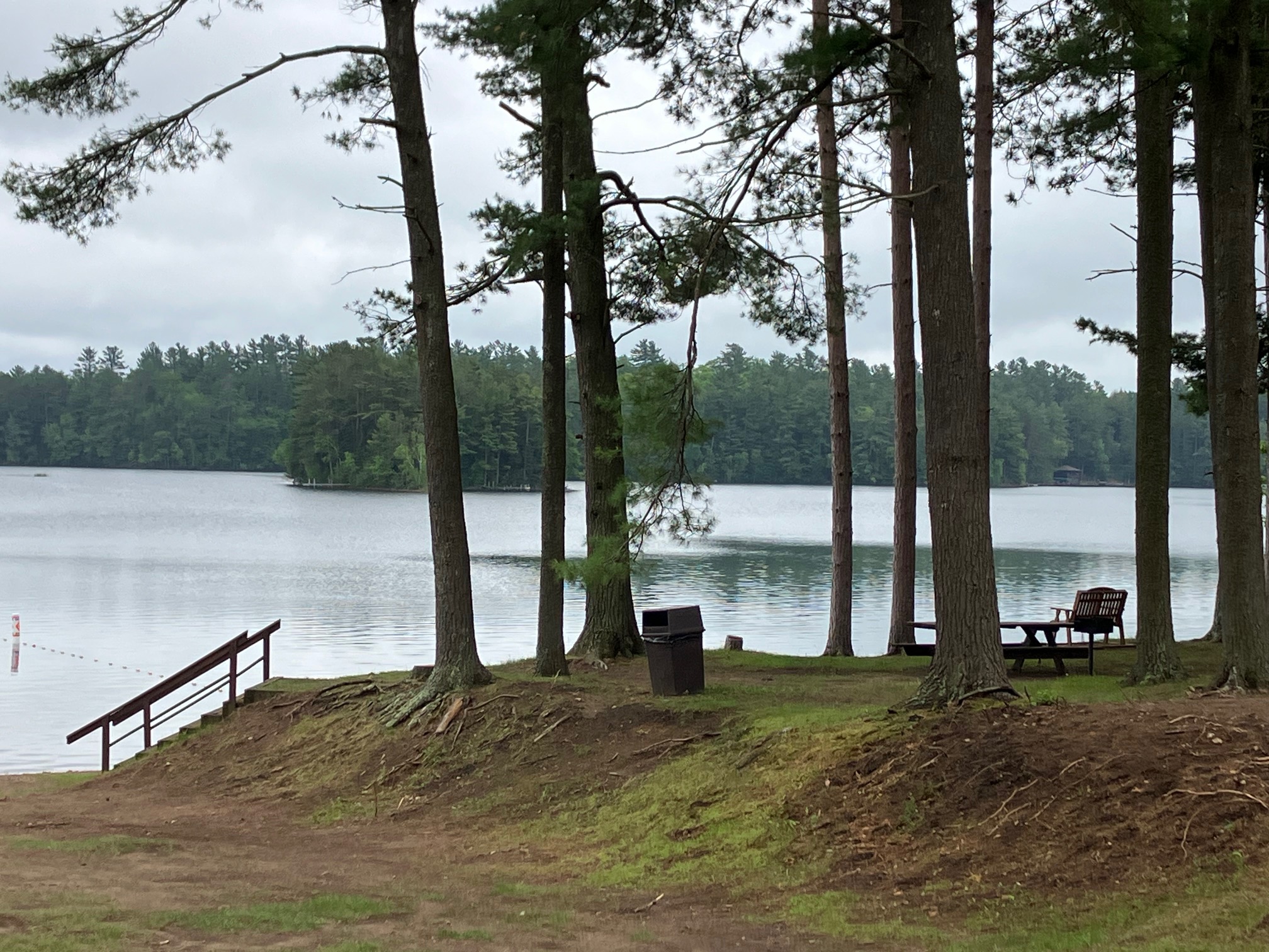 Wooden benches overlooking a calm Northwoods lake