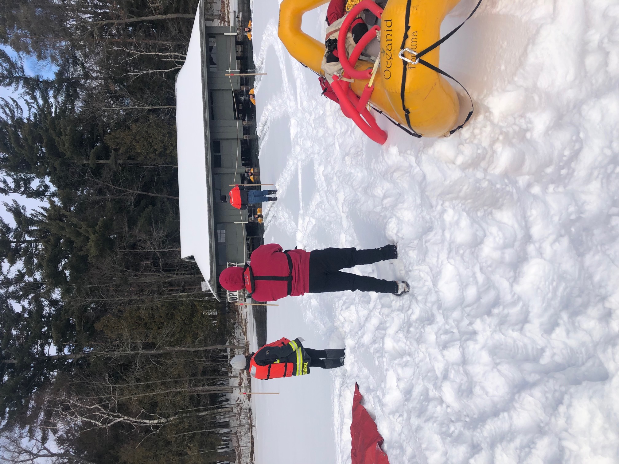 A rescue team and equipment on a snow-covered lake at night