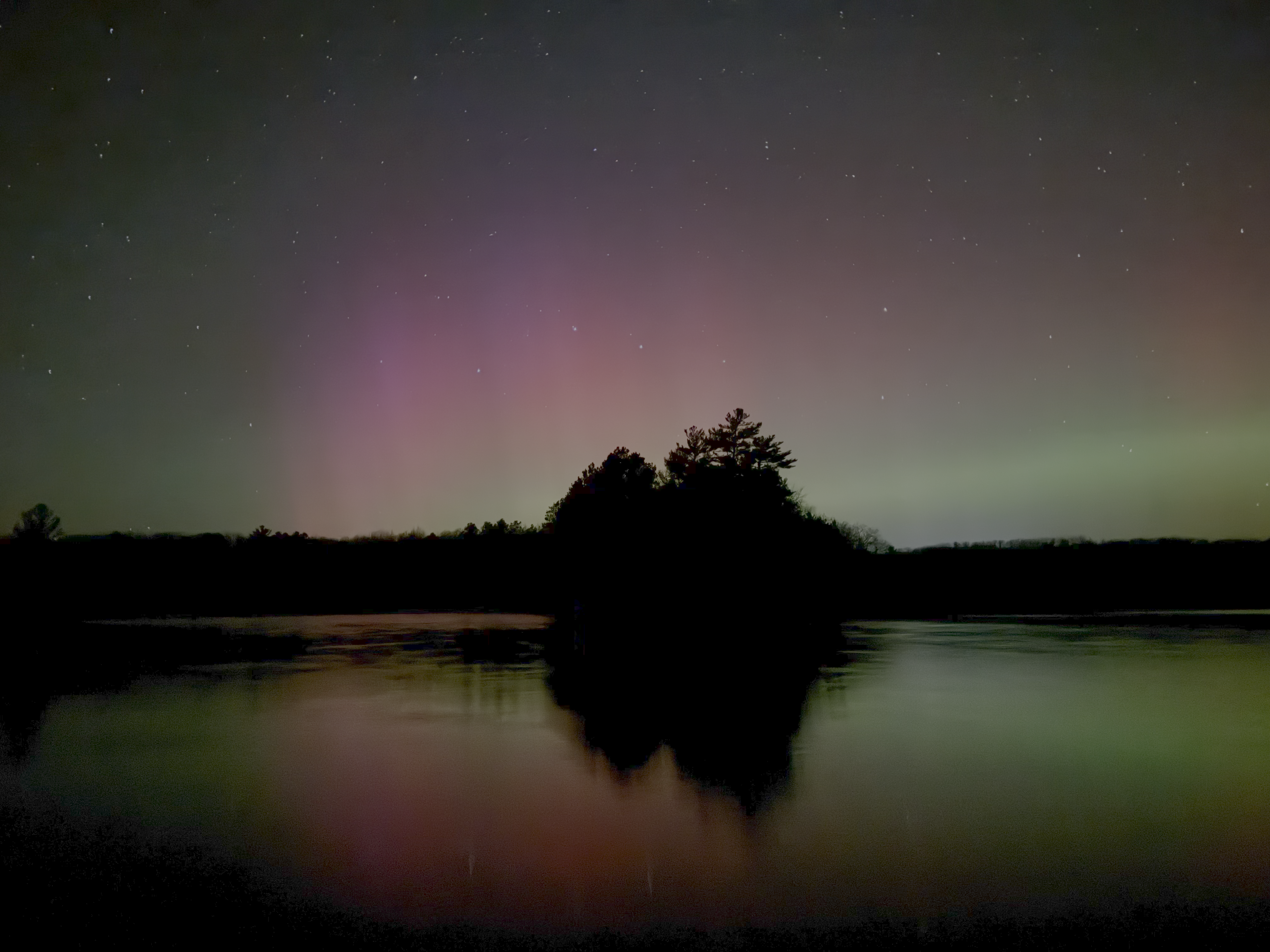 Northern lights shimmering over Lake Katherine in Hazelhurst, Wisconsin