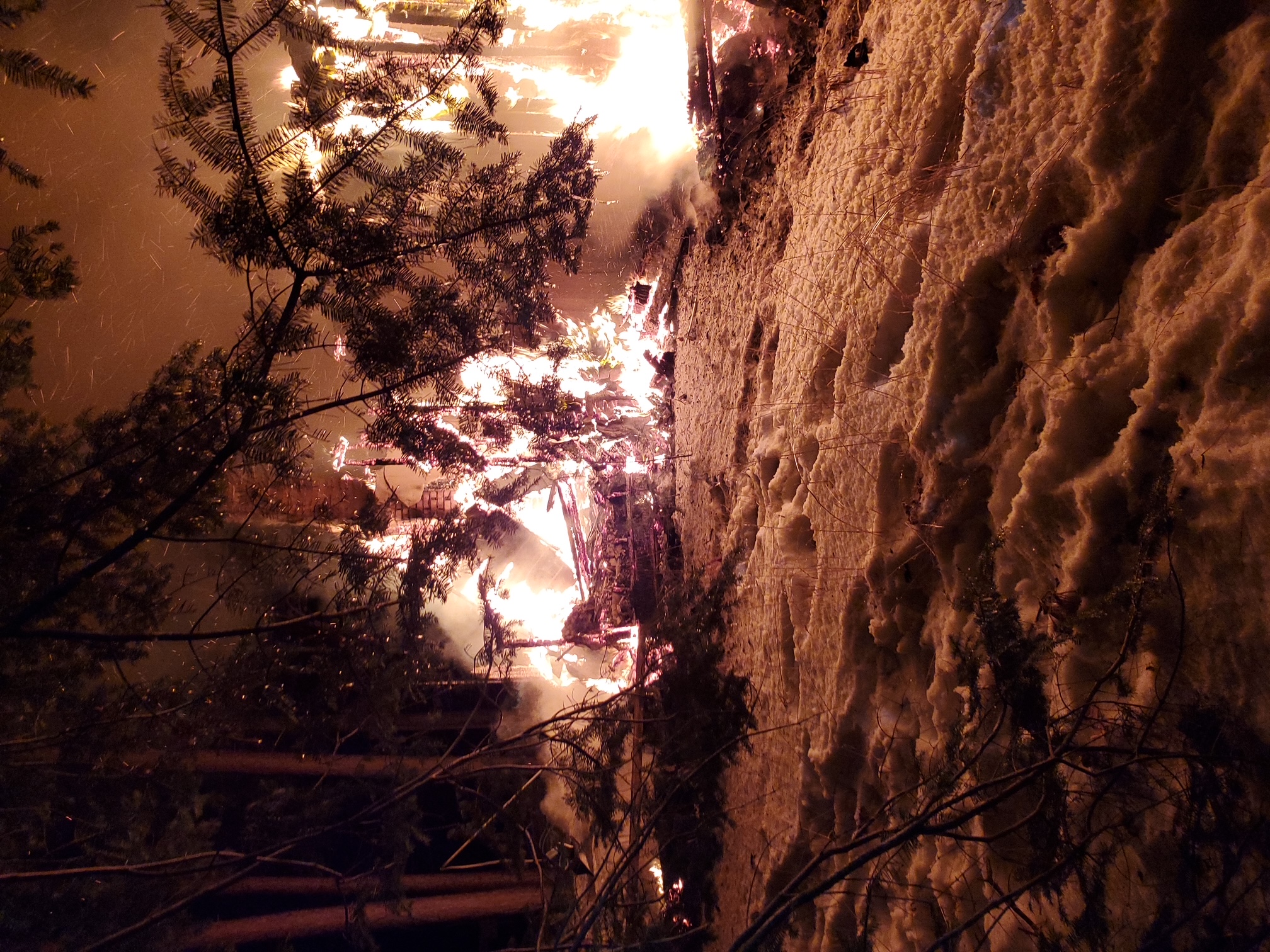 Firefighters training on a structure fire at night