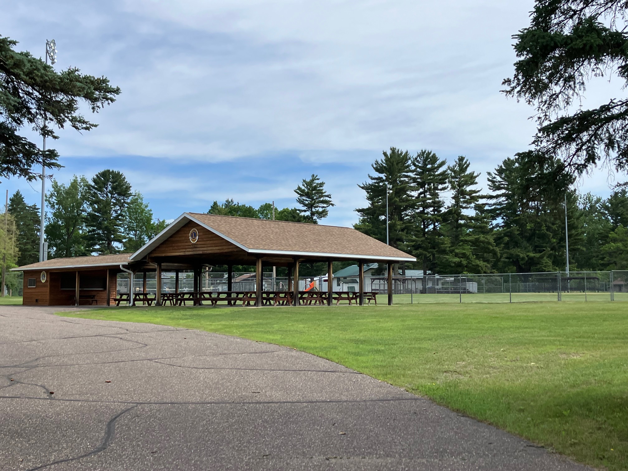 A wooden pavilion overlooking a community sports field